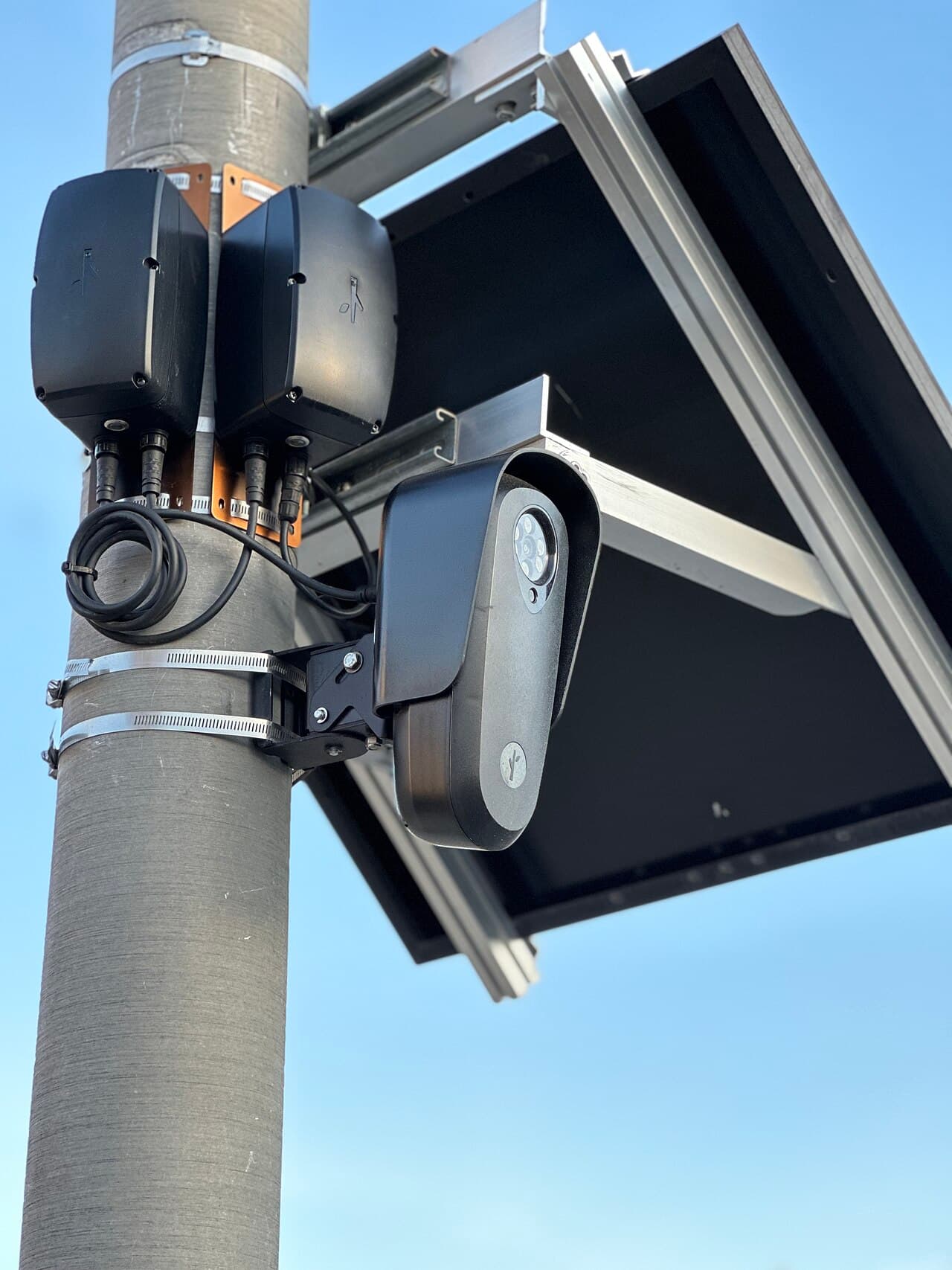 Close-up of a Flock Safety camera unit showing its lens and housing